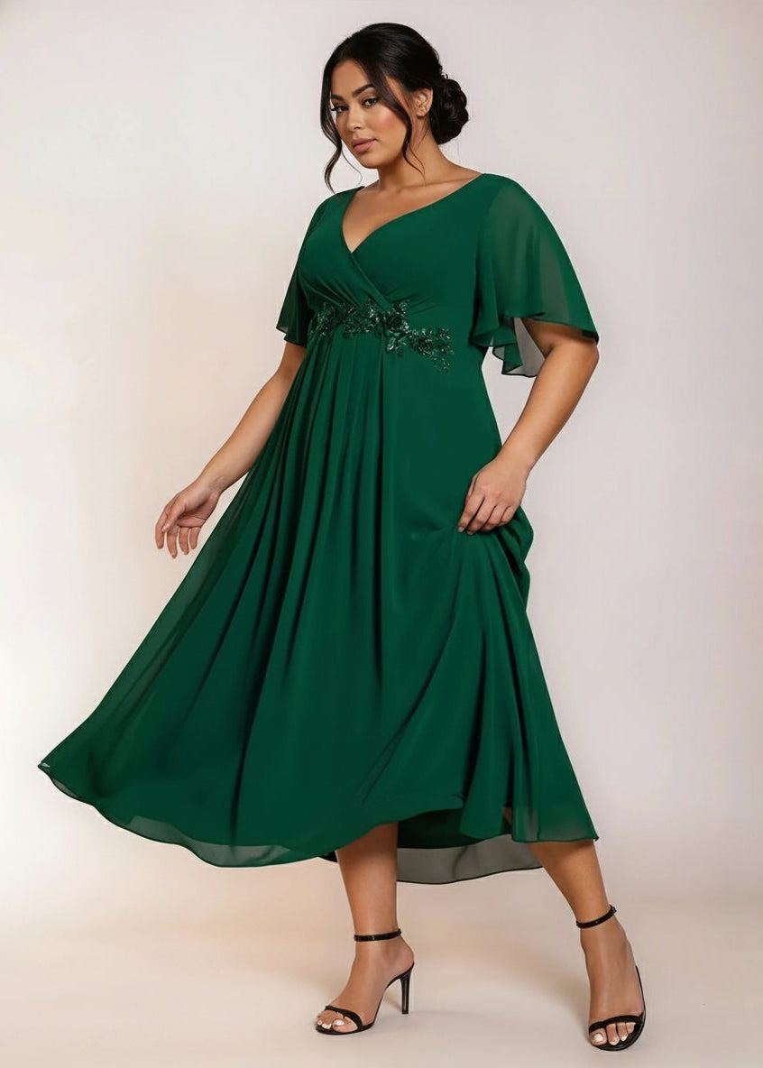 Emerald Mother of the bride/groom dress, full front shot of woman in plus size emerald dress swaying