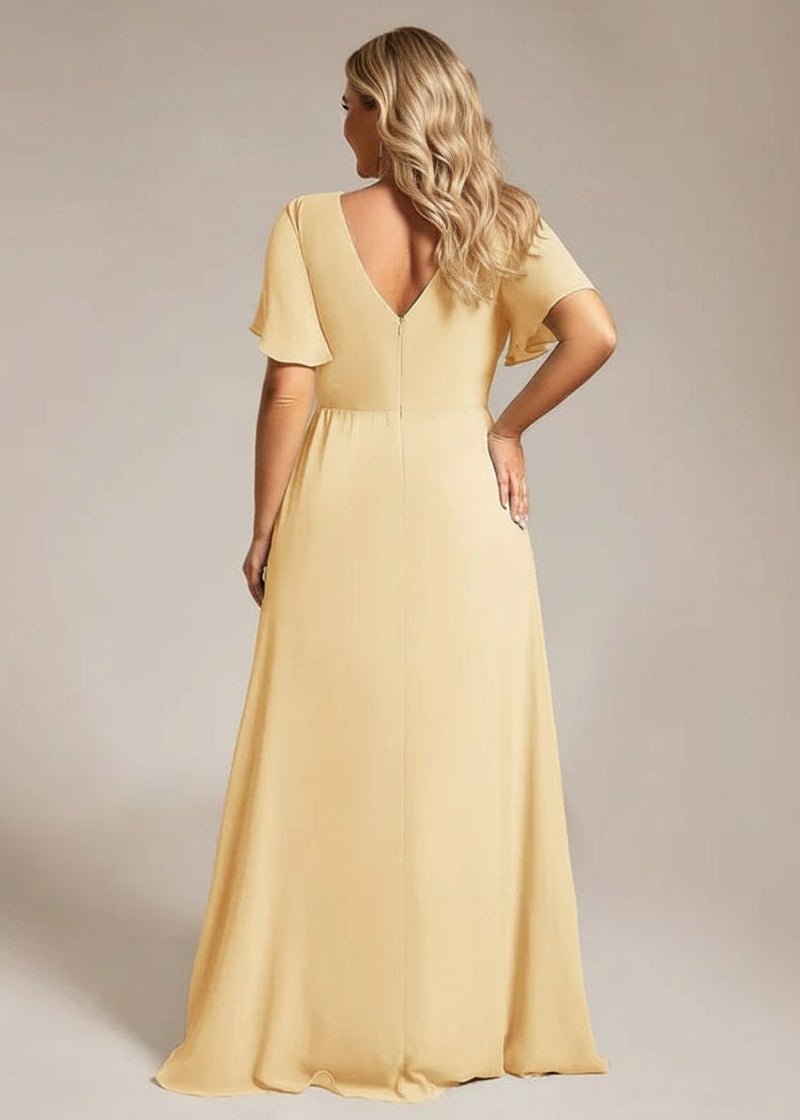 Woman wearing a long yellow dress with a plain background