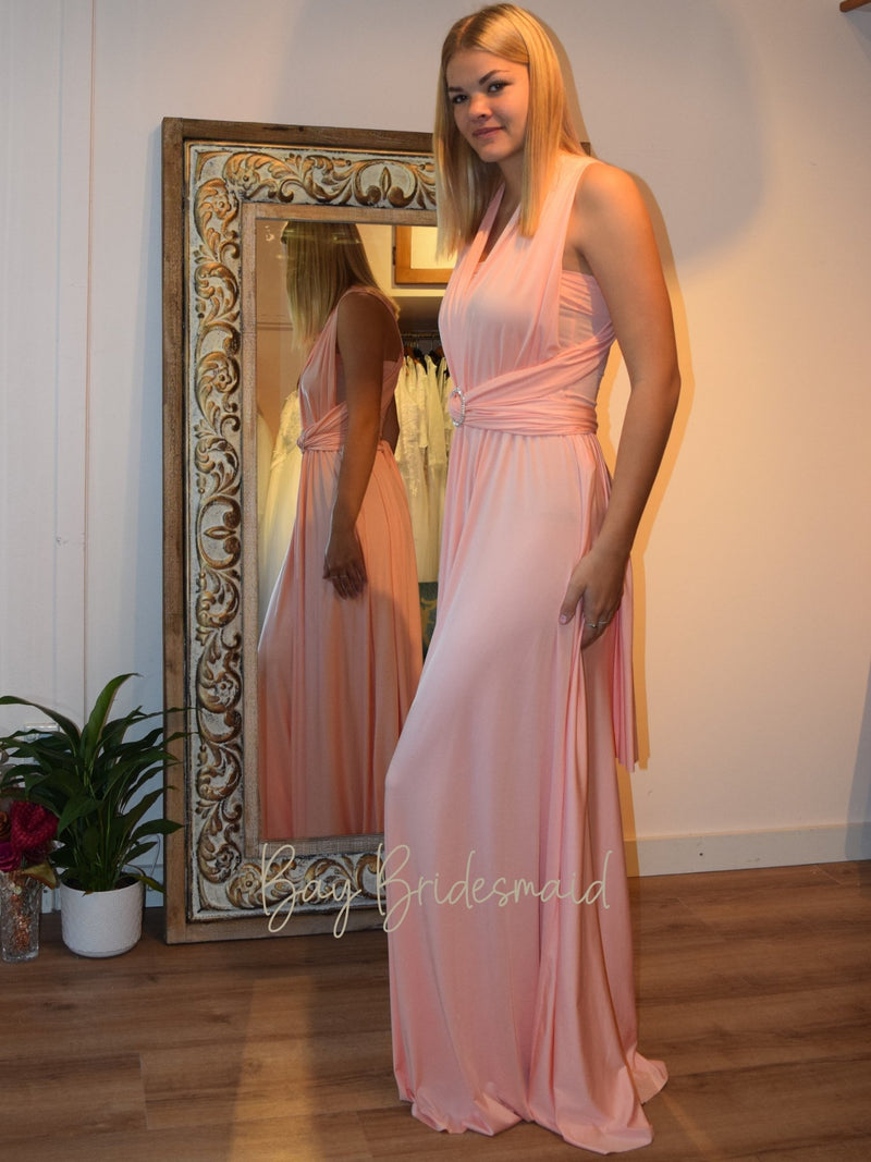 Woman wearing gorgeous Peach Pink convertible Infinity bridesmaid dress