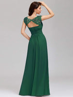 Back shot of woman in elegant sleeve lace and chiffon bridesmaid dress in emerald color