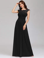 Woman posing in Allanah cap sleeve lace and chiffon bridesmaid dress in black