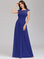 Woman wearing Allanah cap sleeve lace and chiffon evening dress in sapphire